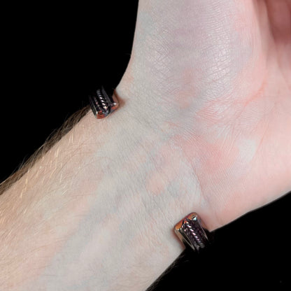 A men's Navajo three stone turquoise cuff bracelet handmade by artist, Dean Brown.  The silver has an iridescent purple patina.