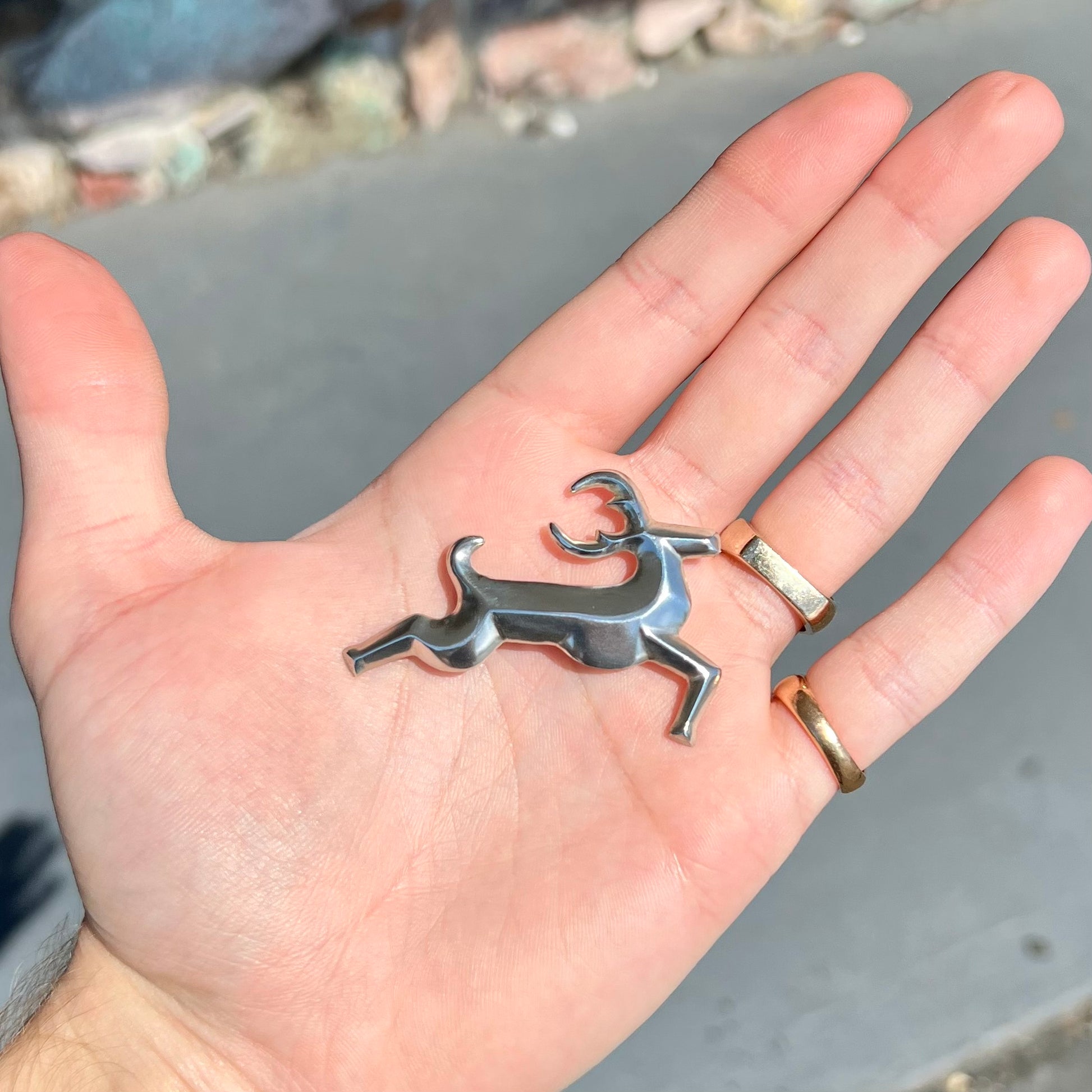 A silver brooch of a jumping deer handmade by Navajo artist Frances Jones.