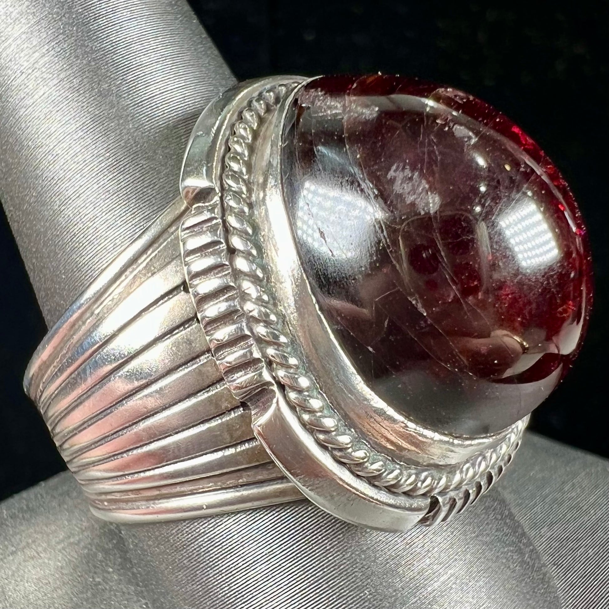 A men's sterling silver garnet ring handmade by Navajo artist Will Denetdale.