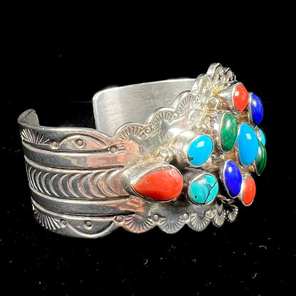 A sterling silver ladies' Navajo cuff bracelet set with turquoise, malachite, lapis lazuli, and coral stones.