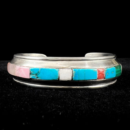 A vintage sterling silver stone inlay cuff bracelet, signed "AHASTEEN" by the Navajo artsit.