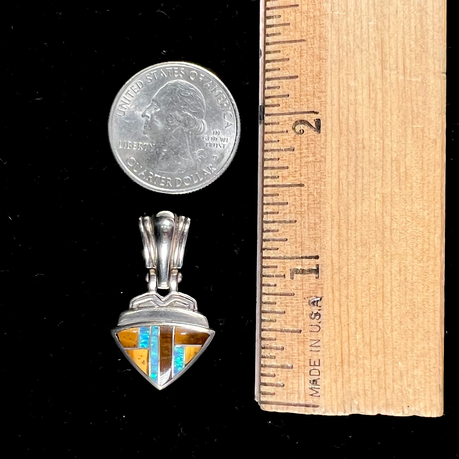 A Navajo-made pendant inlaid with tiger's eye and synthetic opal stones.