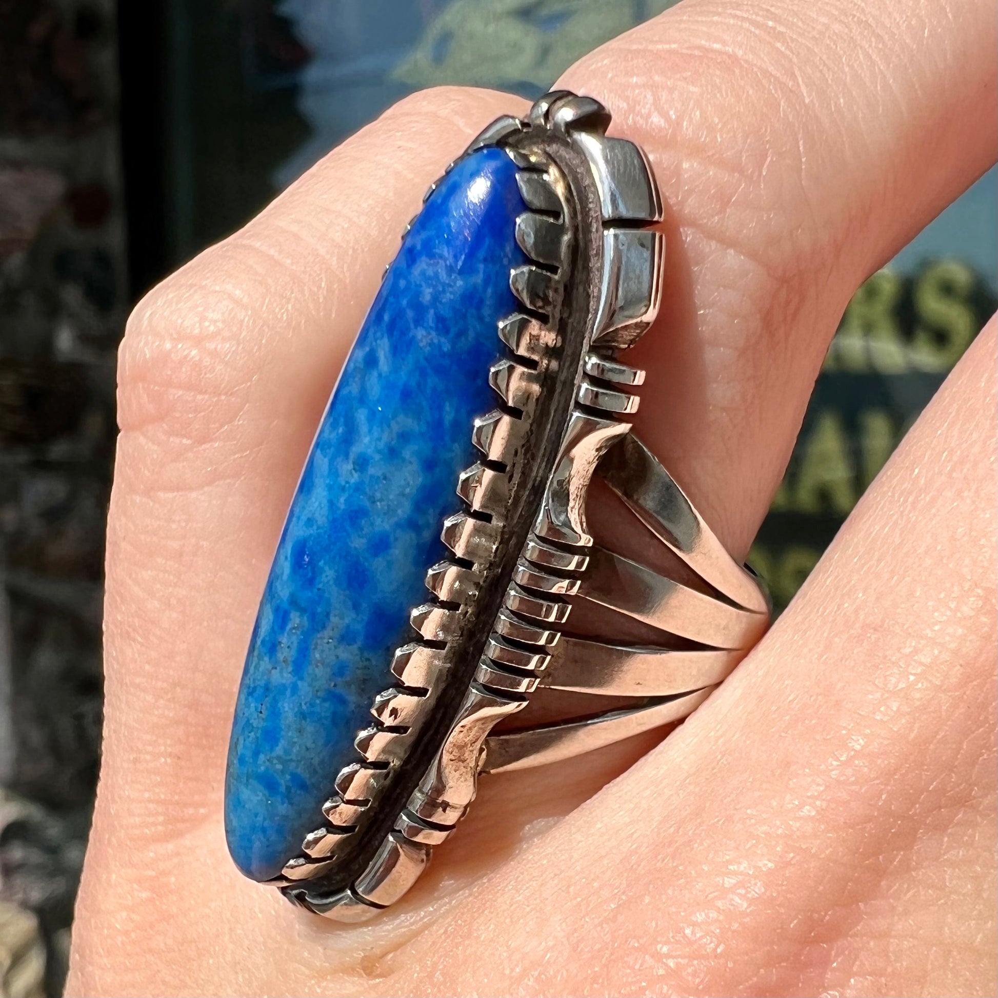 A Navajo style sterling silver lapis lazuli ring engraved with the words "R. Bennett".