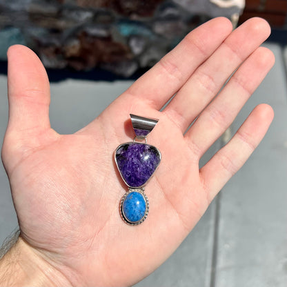 A sterling silver pendant set with polished charoite and lapis lazuli stones, hand signed "KK" by the artist.