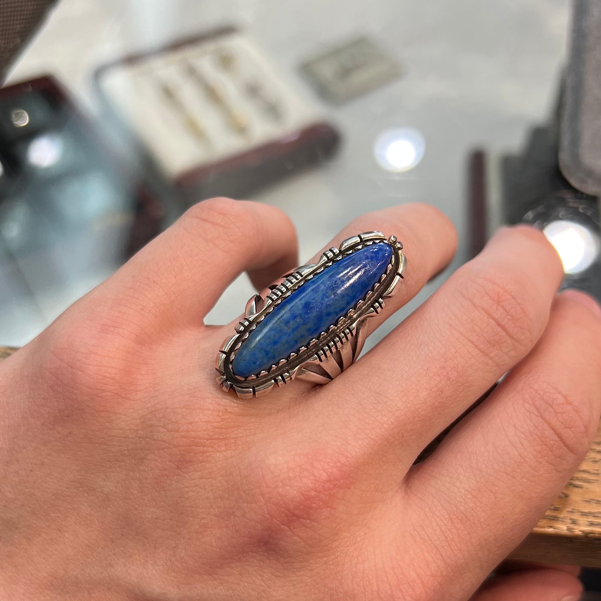 A Navajo style sterling silver lapis lazuli ring engraved with the words "R. Bennett".
