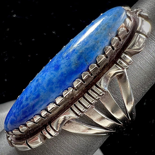 A Navajo style sterling silver lapis lazuli ring engraved with the words "R. Bennett".