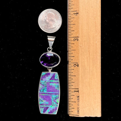 A sterling silver stone inlay necklace set with amethyst, sugilite, spiderweb turquoise, and lab created opal by Navajo artist, Peterson Chee.