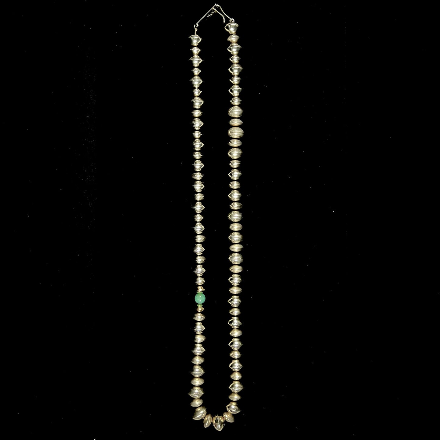 A silver, gold, and chrysoprase bead necklace handmade by Navajo artist, Alfred Joe.