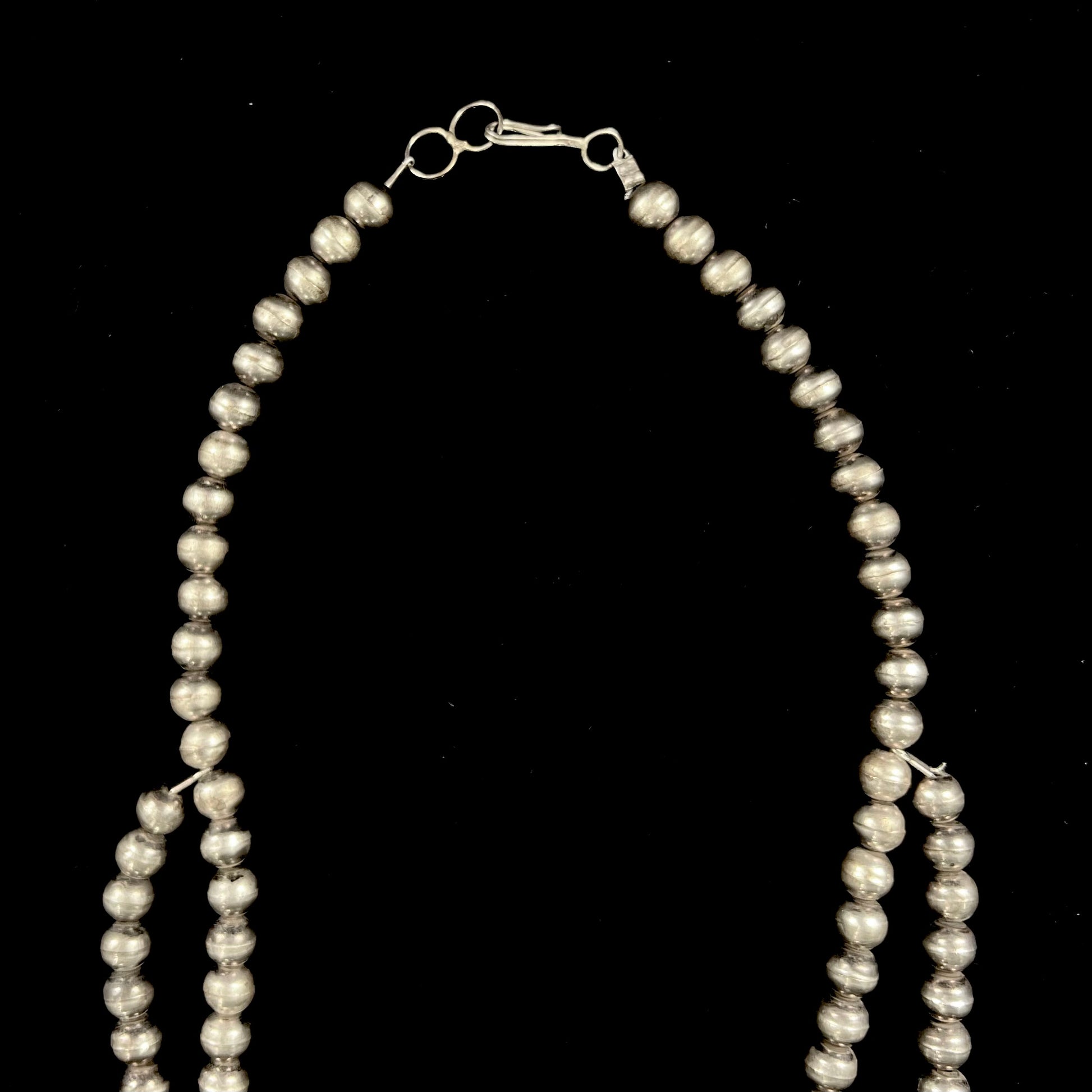 A men's Navajo silver squash blossom necklace set with Kingman turquoise stones.