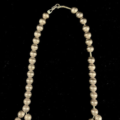 A silver Navajo men's squash blossom necklace set with Fox turquoise and Sonora turquoise.