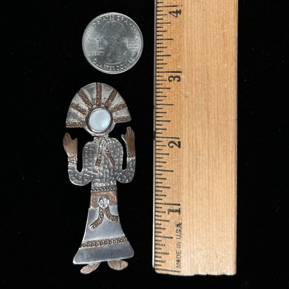 A handmade Navajo style silver pendant with copper highlights shaped like a Navajo Indian shaman.  There is a mother of pearl set as the shaman's face.