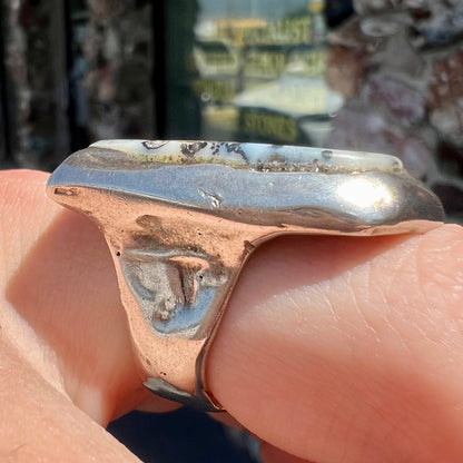 A bezel set ring handmade in sterling silver with a white dendritic agate stone.