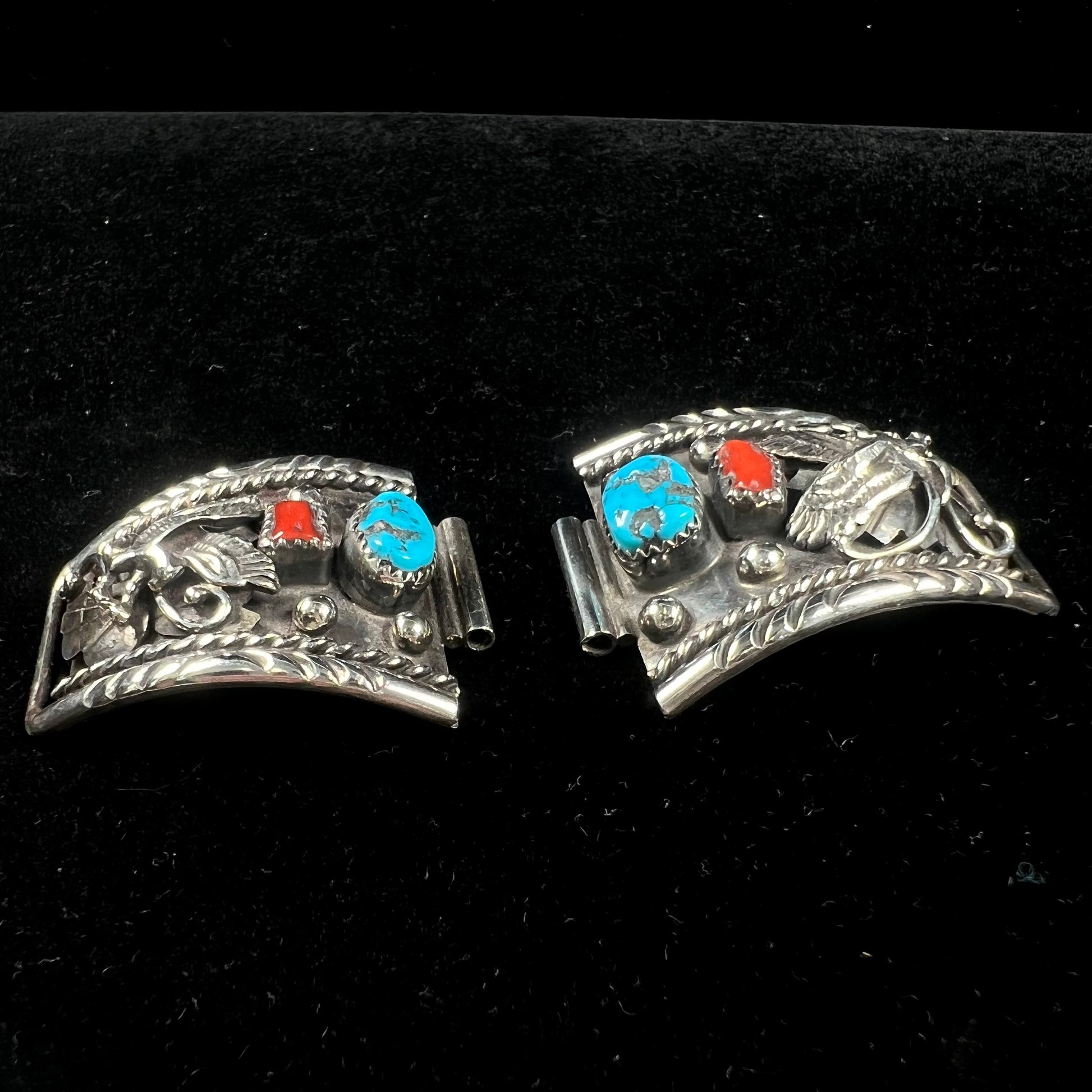 A pair of sterling silver watch cuff parts set with turquoise and coral stones handmade by Navajo artist, Genieve Werito.