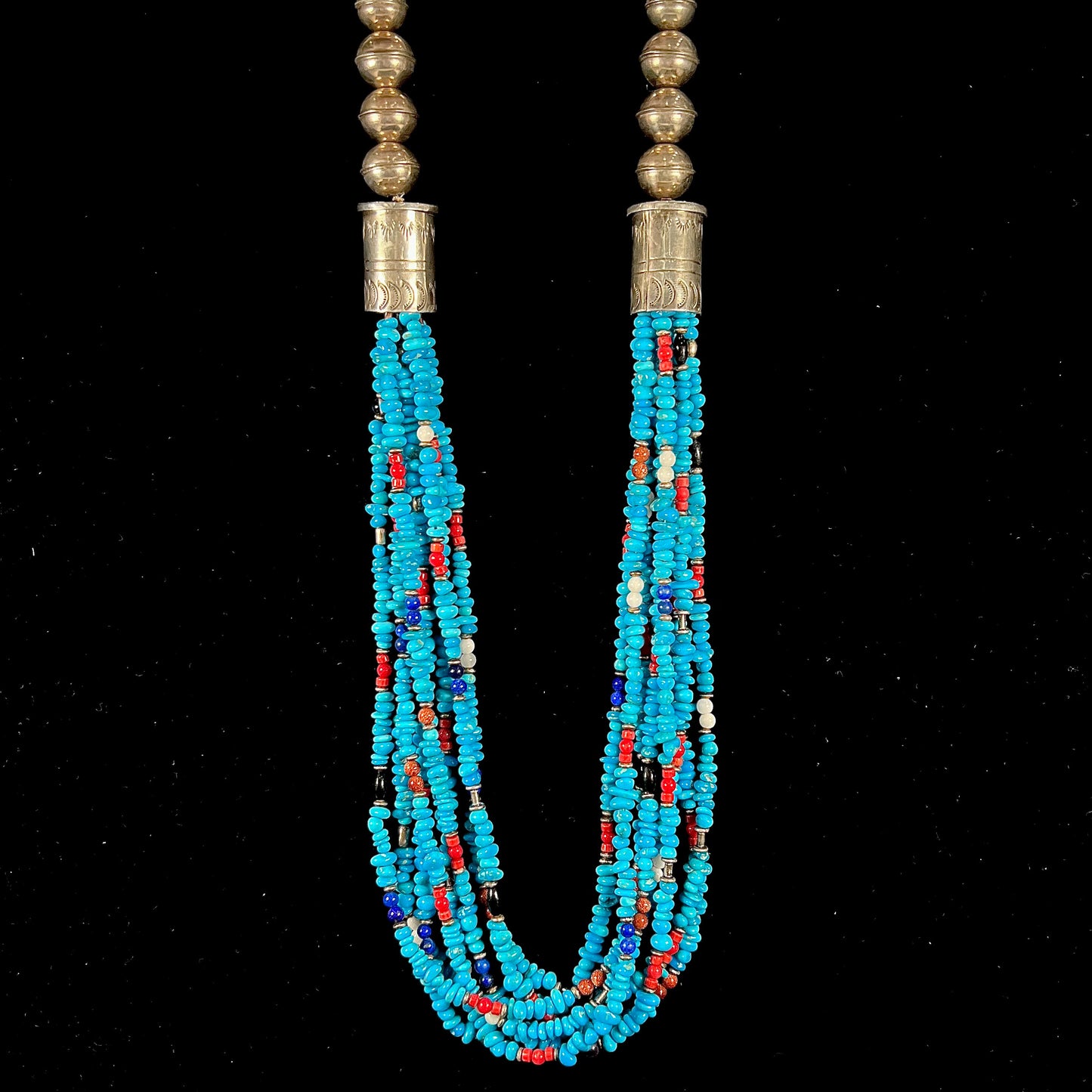 A Navajo Indian-made multistrand Sleeping Beauty turquoise bead necklace with coral, lapis lazuli, goldstone, and onyx accents.