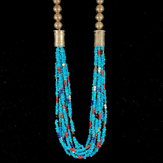 A Navajo Indian-made multistrand Sleeping Beauty turquoise bead necklace with coral, lapis lazuli, goldstone, and onyx accents.