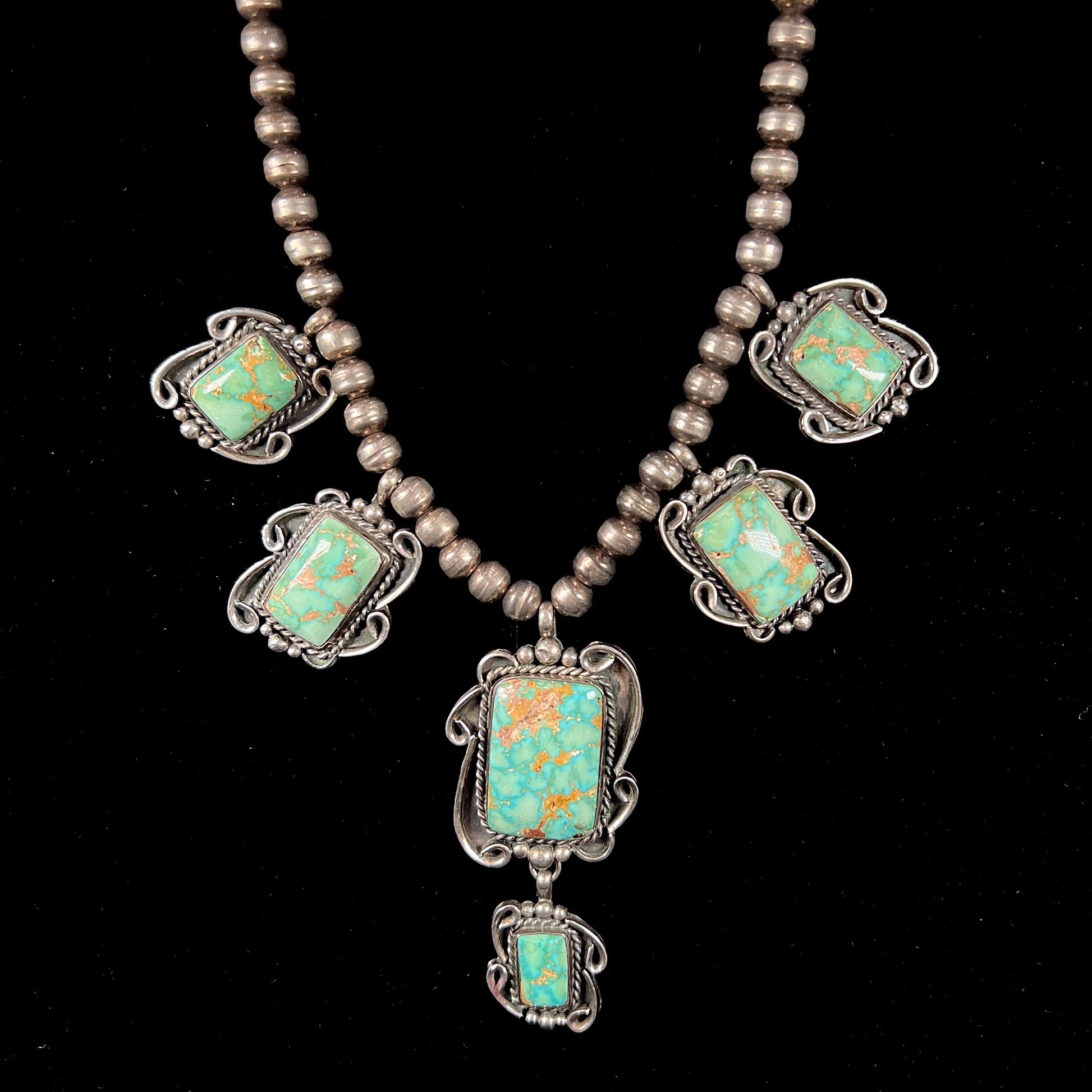 A sterling silver Navajo turquoise necklace set with Pilot Mountain Mine turquoise stones by artist Minnie Thomas.