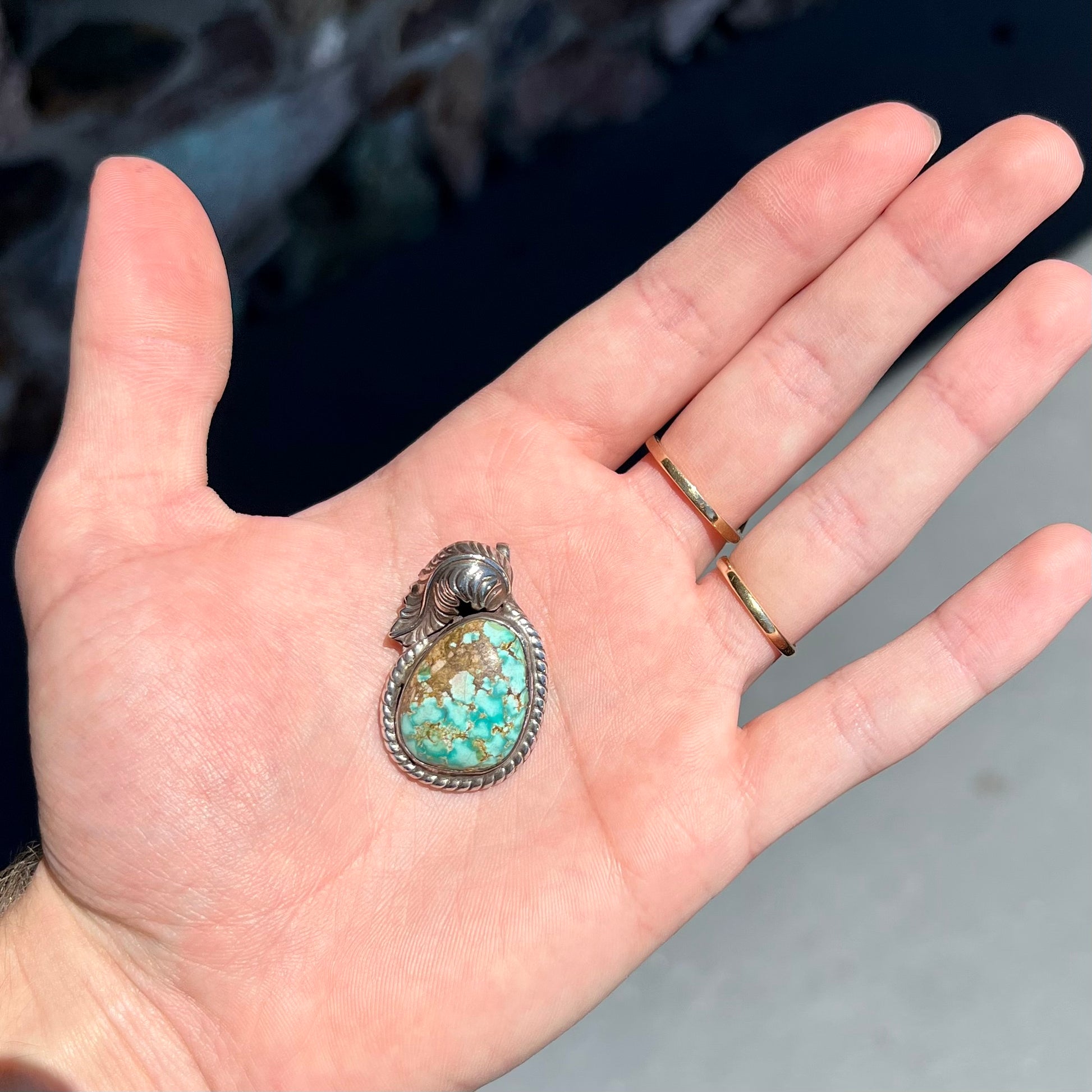 A handmade silver Navajo style pendant set with a turquoise stone from Kingman, Arizona.