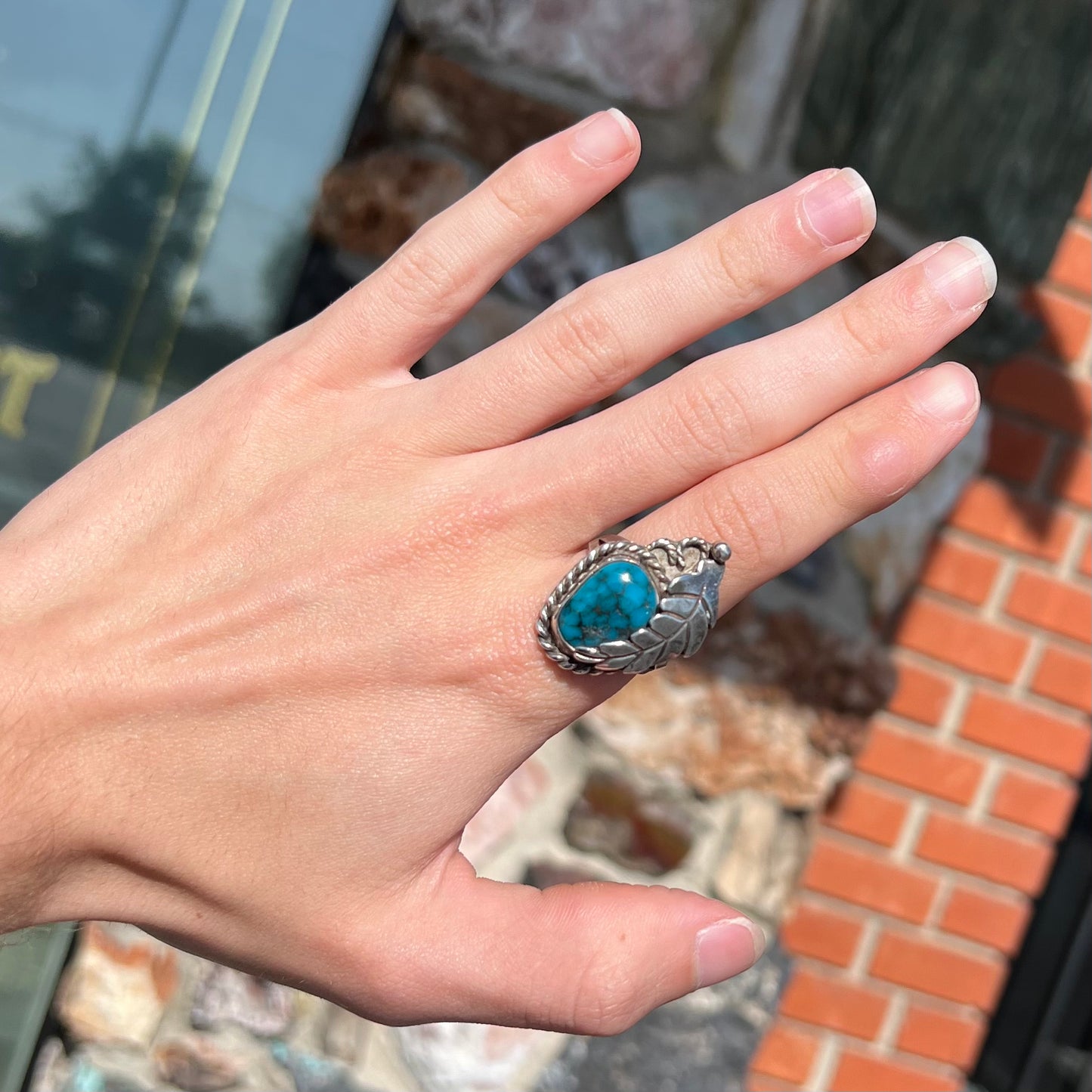 A handmade Navajo men's turquoise ring.  The ring is made with wire and carved silver.