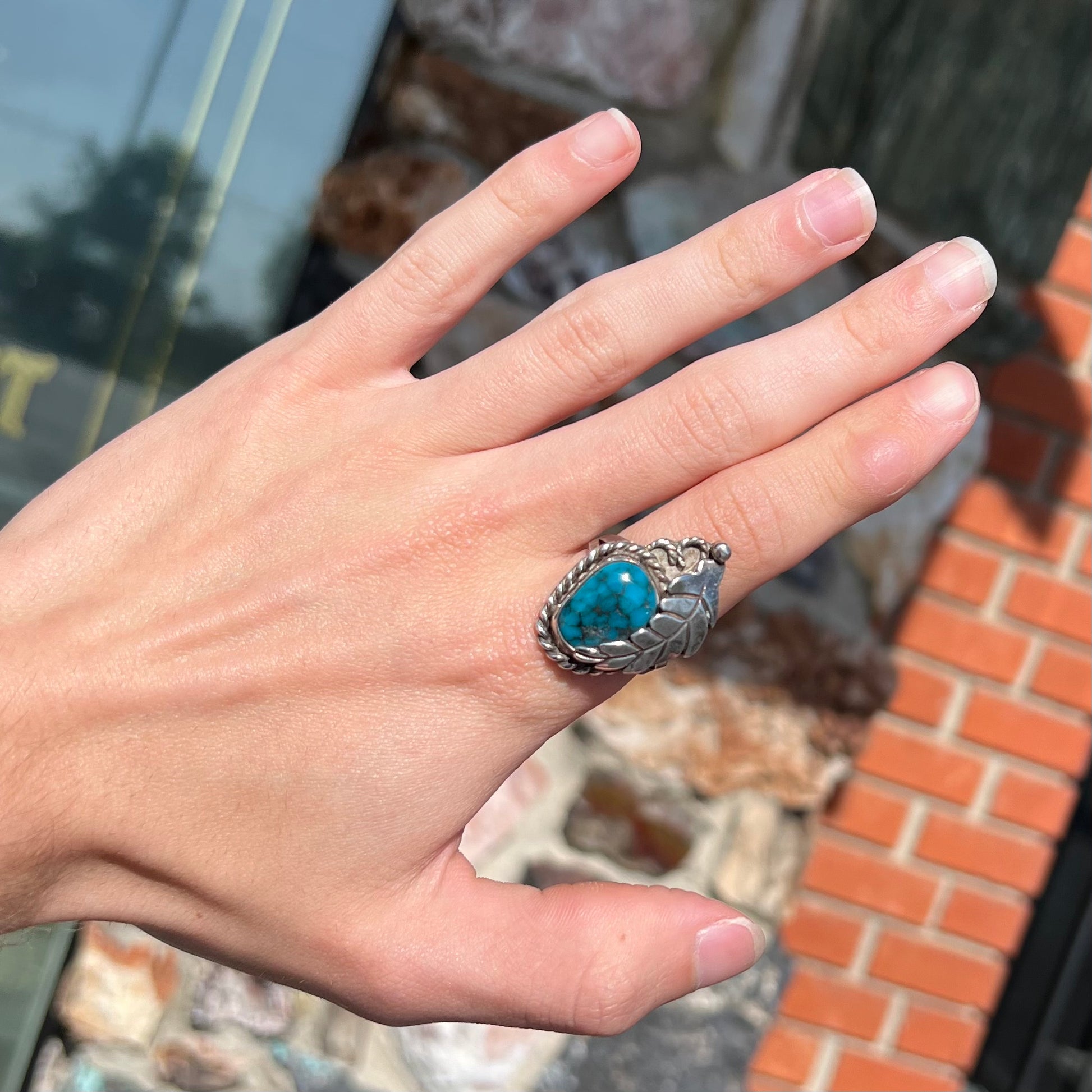 A handmade Navajo men's turquoise ring.  The ring is made with wire and carved silver.