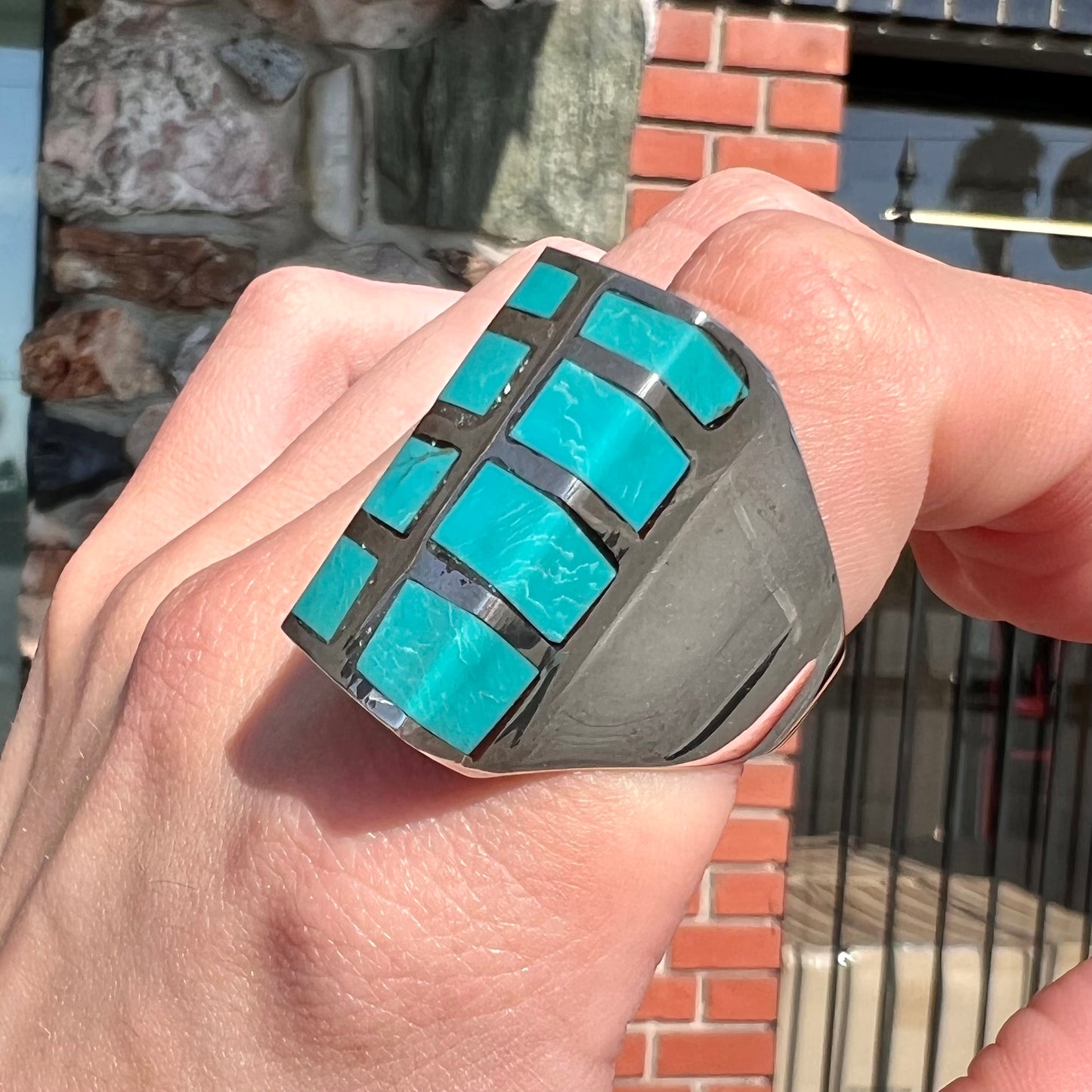 A men's sterling silver turquoise inlay ring, circa 1970.  The piece is set with 8 stones.