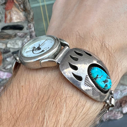 A watch set with two turquoise stones handmade by Navajo artists Arnold and Carleena Goodluck.