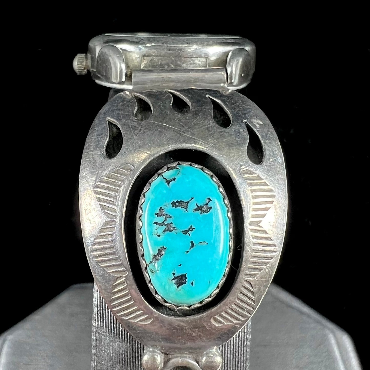 A watch set with two turquoise stones handmade by Navajo artists Arnold and Carleena Goodluck.