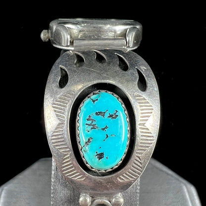 A watch set with two turquoise stones handmade by Navajo artists Arnold and Carleena Goodluck.