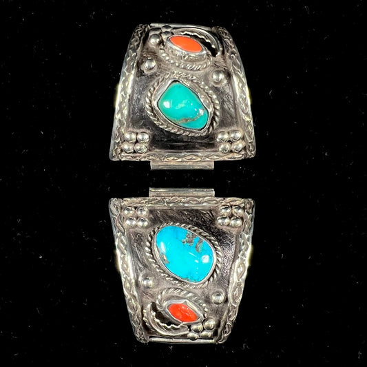 A pair of Navajo made sterling silver watch cuffs set with turquoise and coral stones.