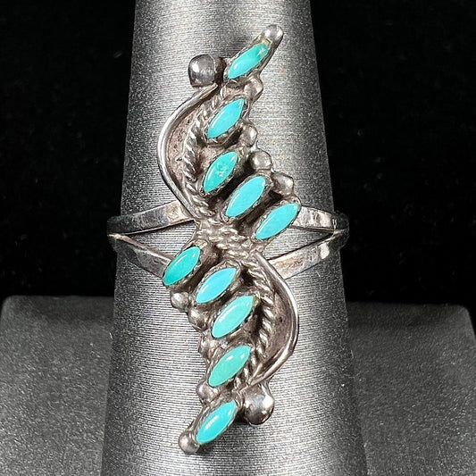 A Zuni needlepoint turquoise ring set in sterling silver.