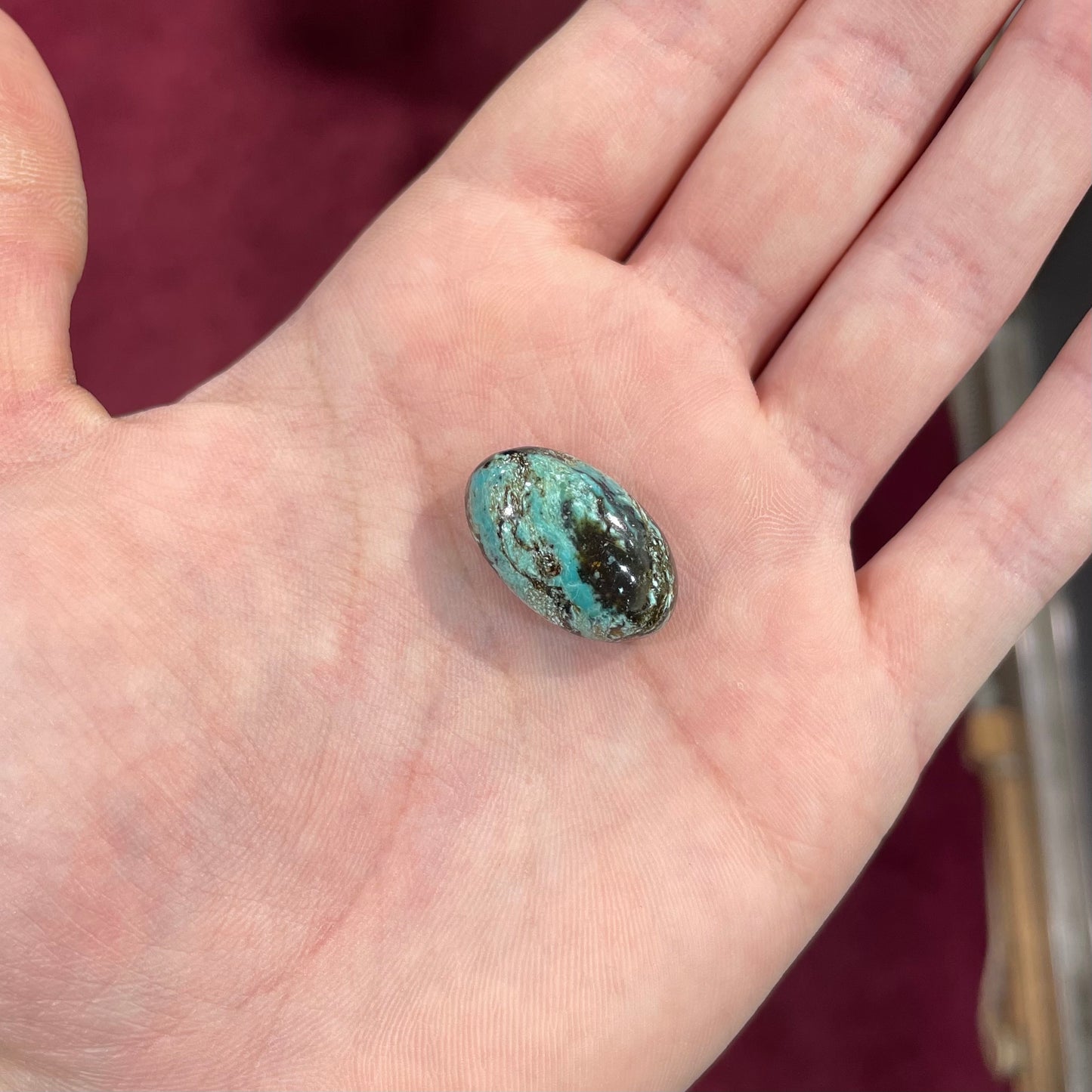 A loose, oval cabochon cut Royston turquoise stone from Nevada.