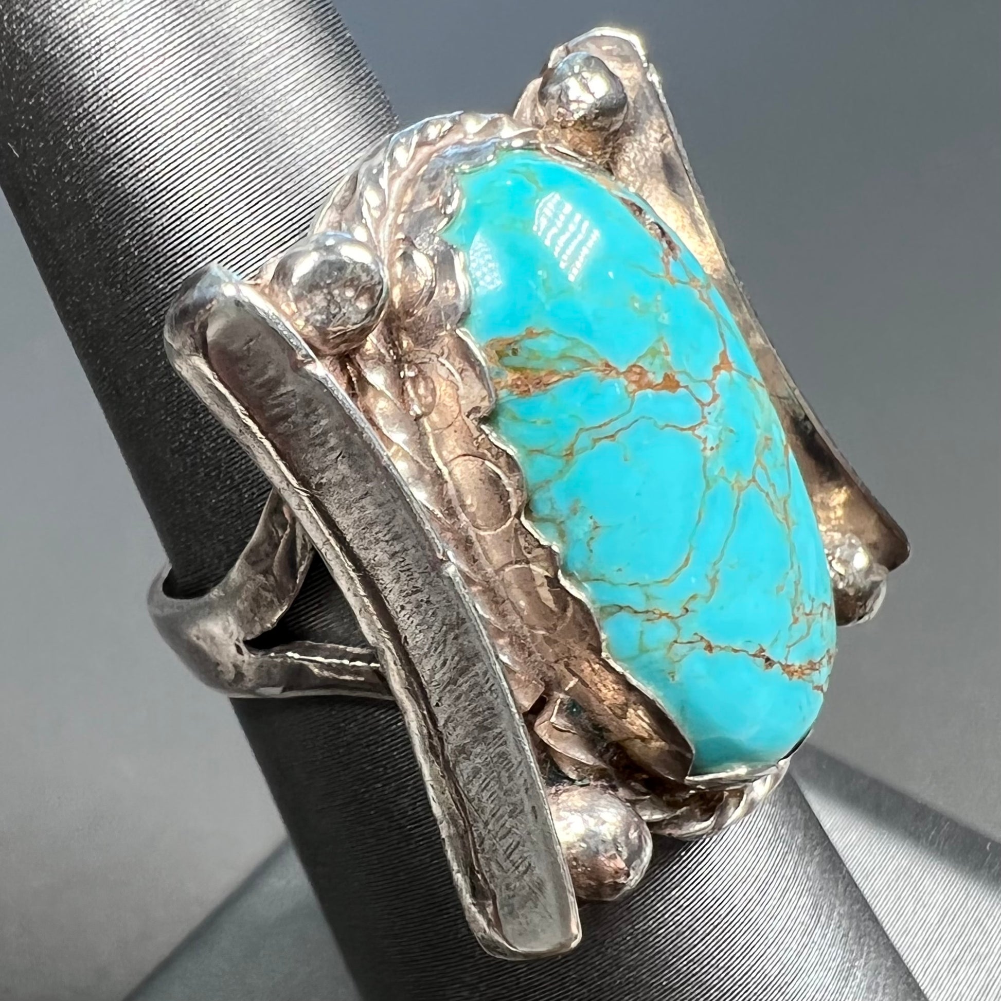 A sterling silver ring set with Tyrone turquoise from Burro Mountains, New Mexico.