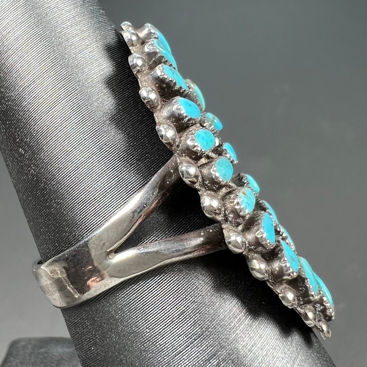 A petit point silver Zuni turquoise ring handmade by New Mexico artist Milburn Dishta.