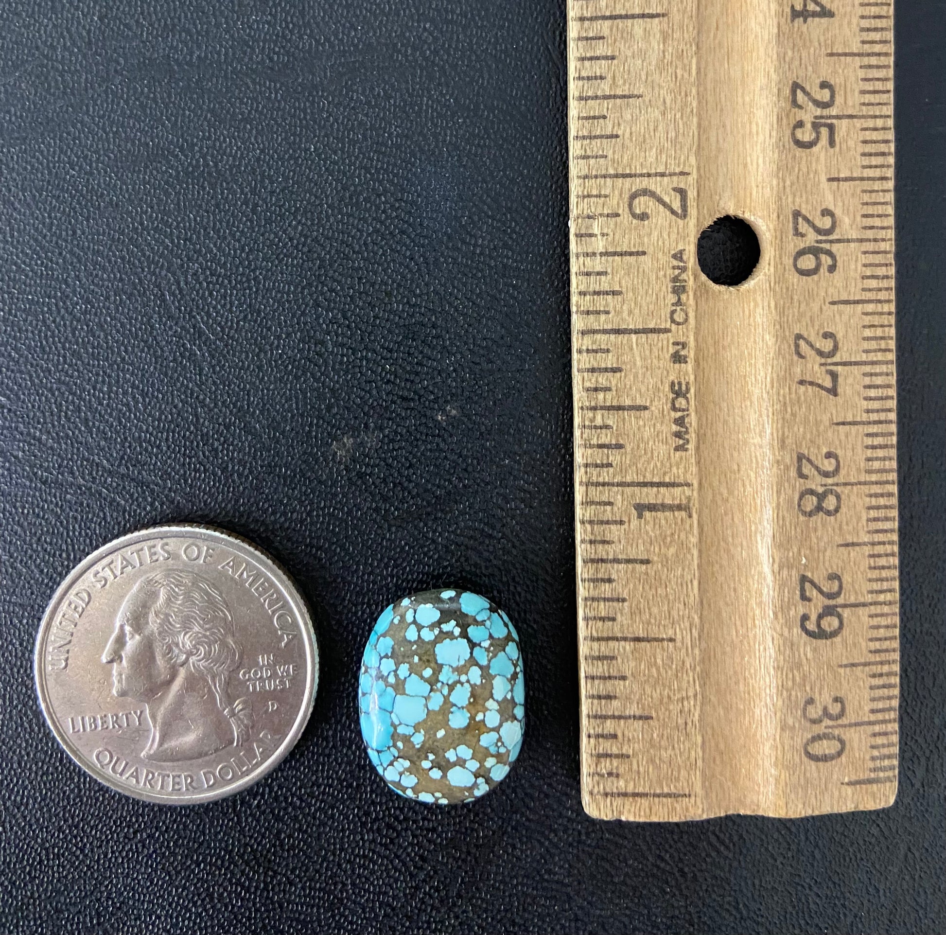 A light blue spiderweb turquoise stone with a greenish brown matrix from Number 8 Mine in Lander County, Nevada.