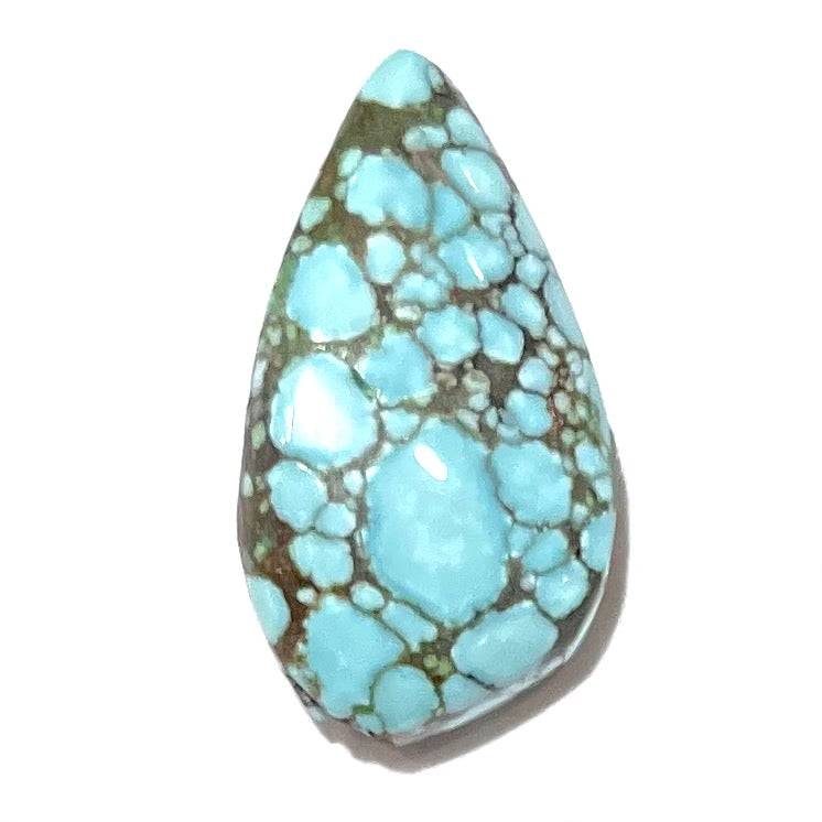 A loose, drop shaped turquoise stone from Number 8 Mine, Nevada.