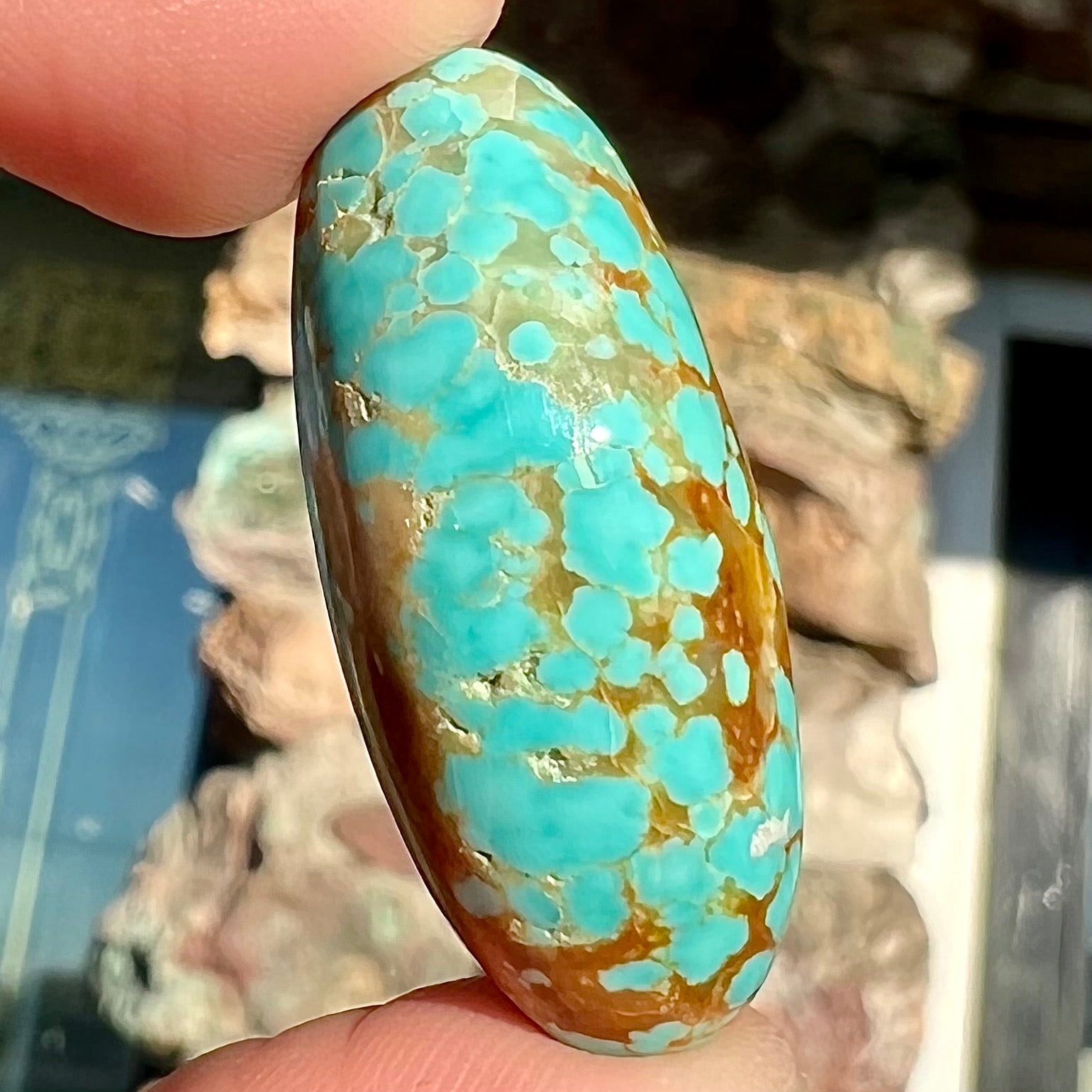 An oval cabochon cut loose turquoise stone from the Number 8 Mine in Nevada.  Blue with chocolate matrix.
