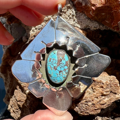 A handmade Mayan Indian pendant set with an oval cut turquoise stone from the Number 8 Mine.