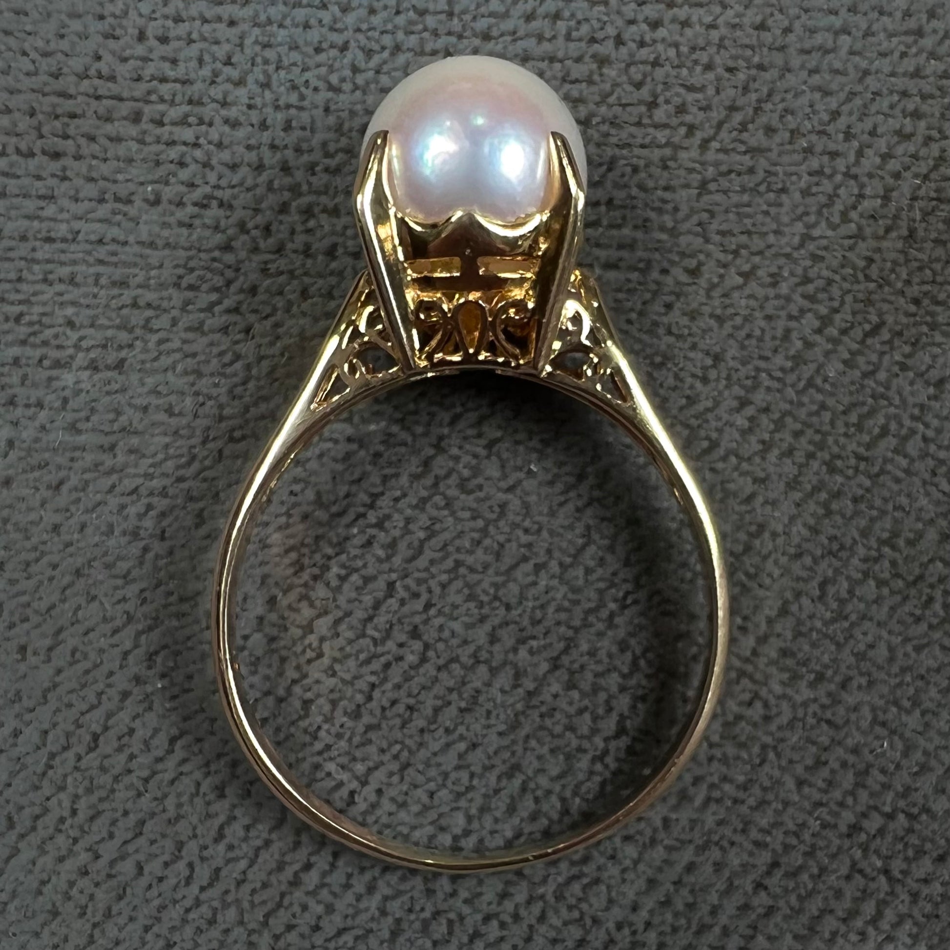 Round white pearl with pink overtones set in a vintage 18k yellow gold ring.