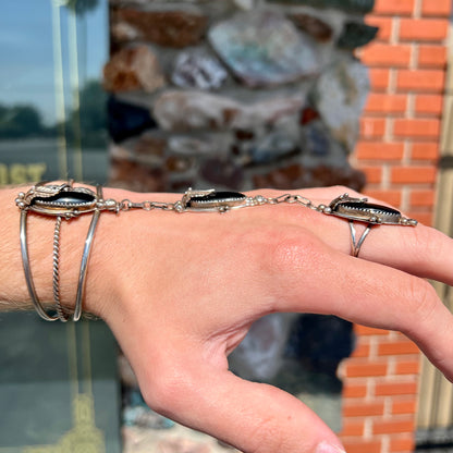 A sterling silver Hopi style onyx slave bracelet and ring set.