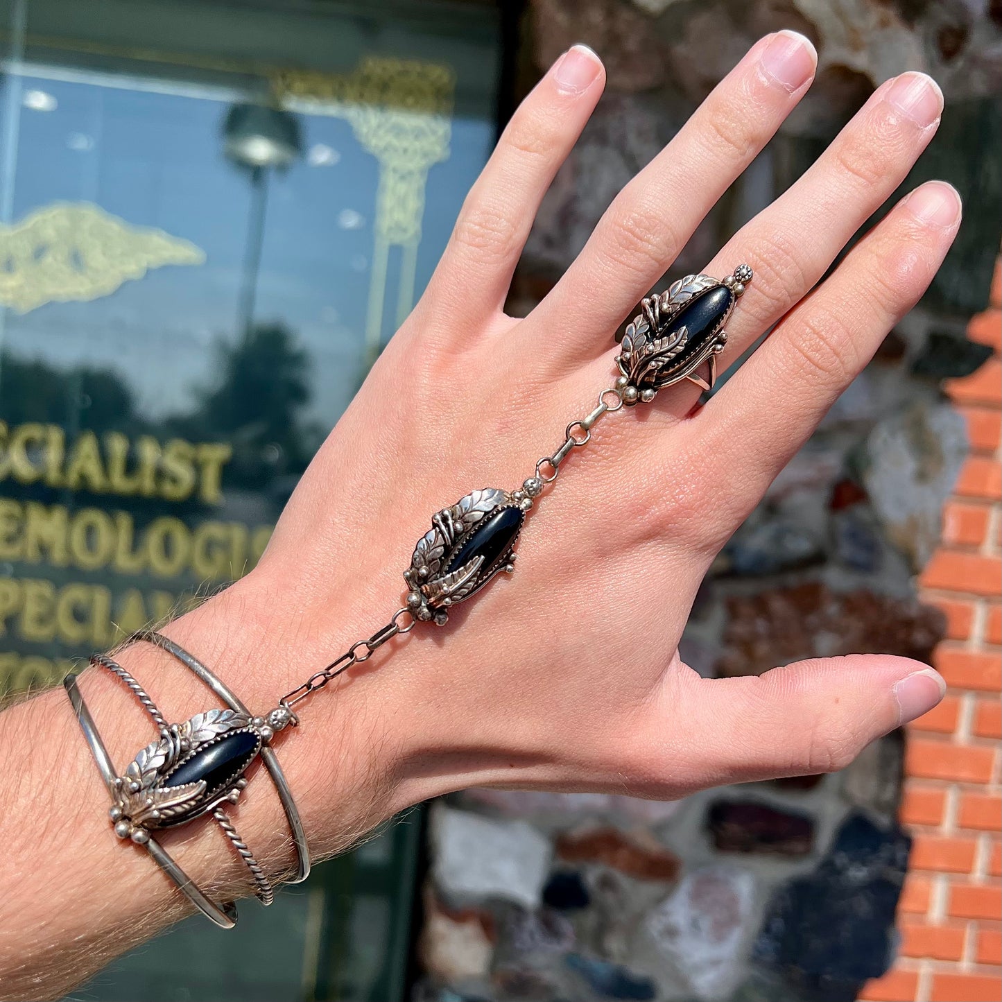 A sterling silver Hopi style onyx slave bracelet and ring set.