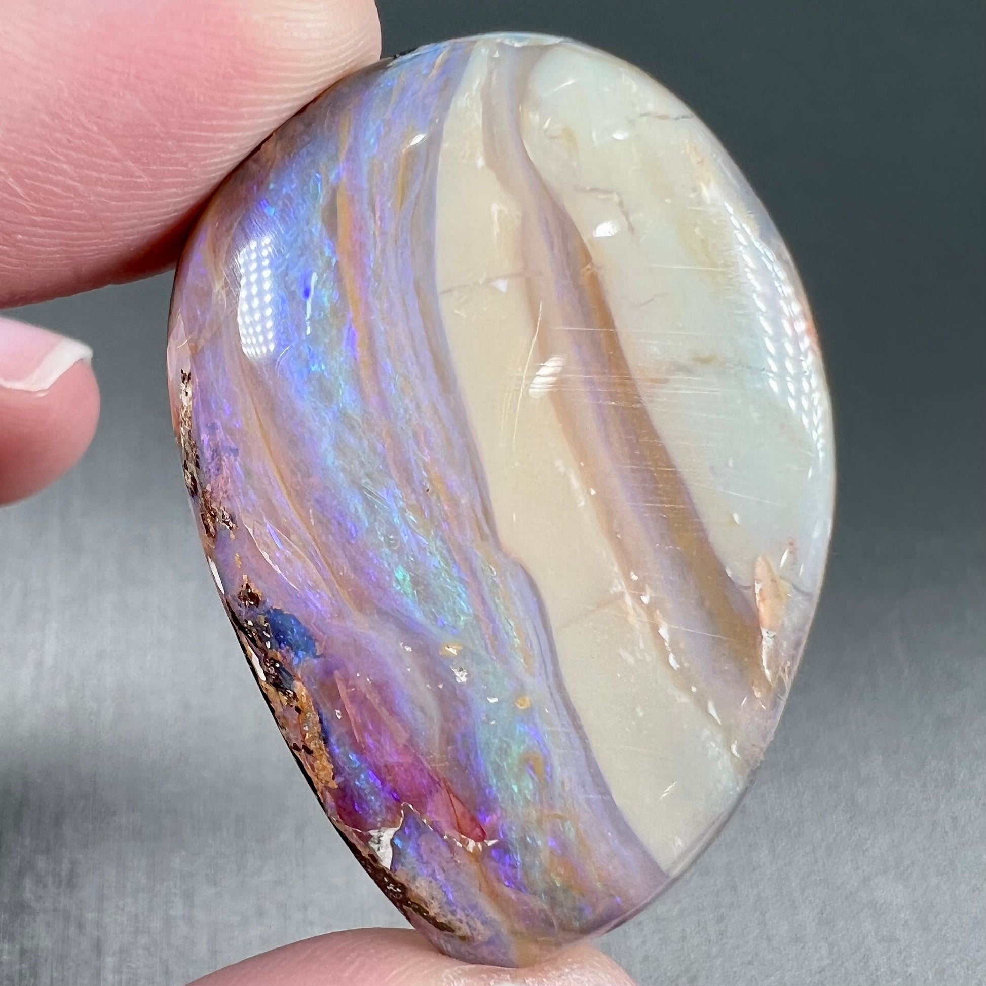 A loose, drop shaped Australian boulder opal from Quilpie Mining District.