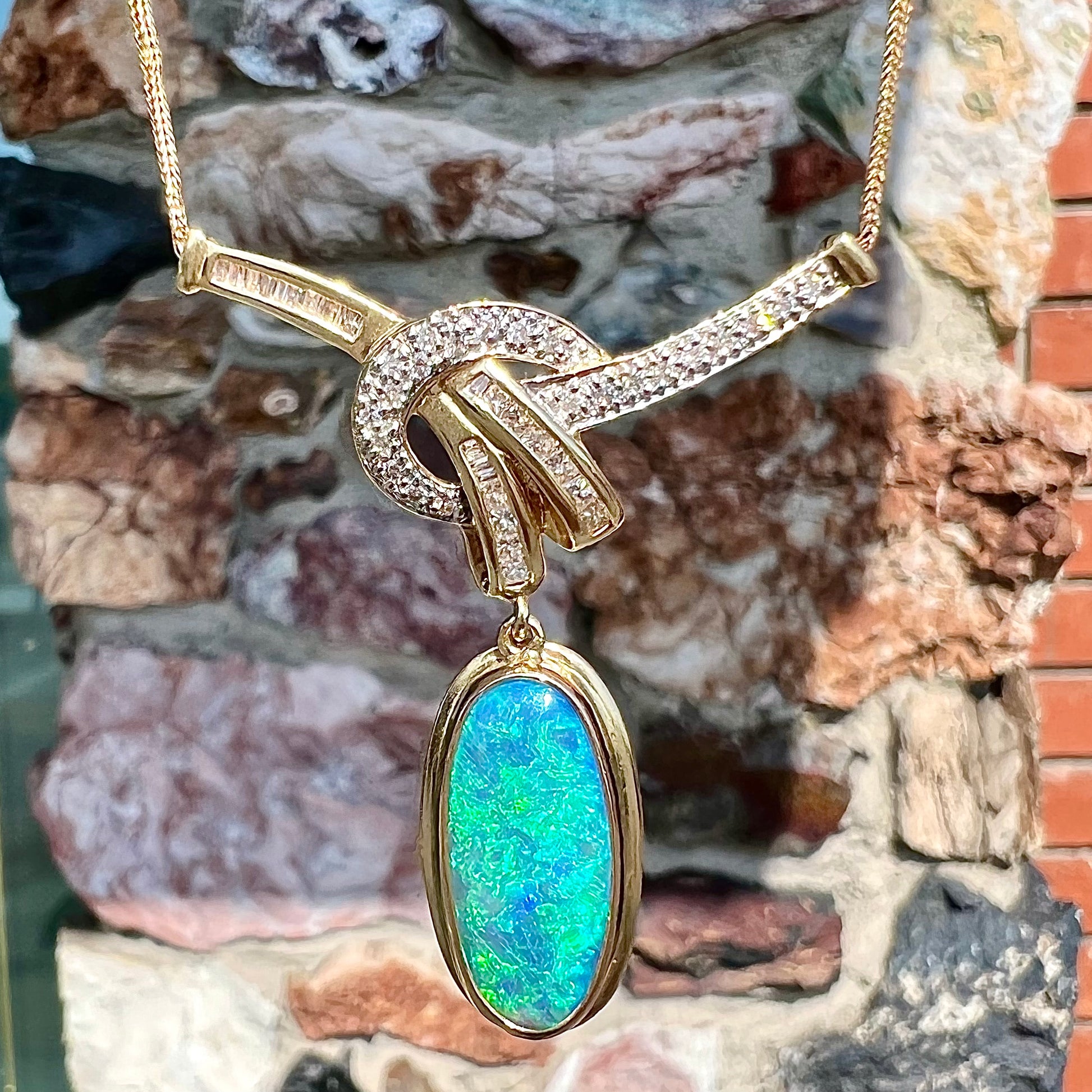 A gold black opal and diamond necklace.  There are round, princess cut, and baguette cut diamonds.