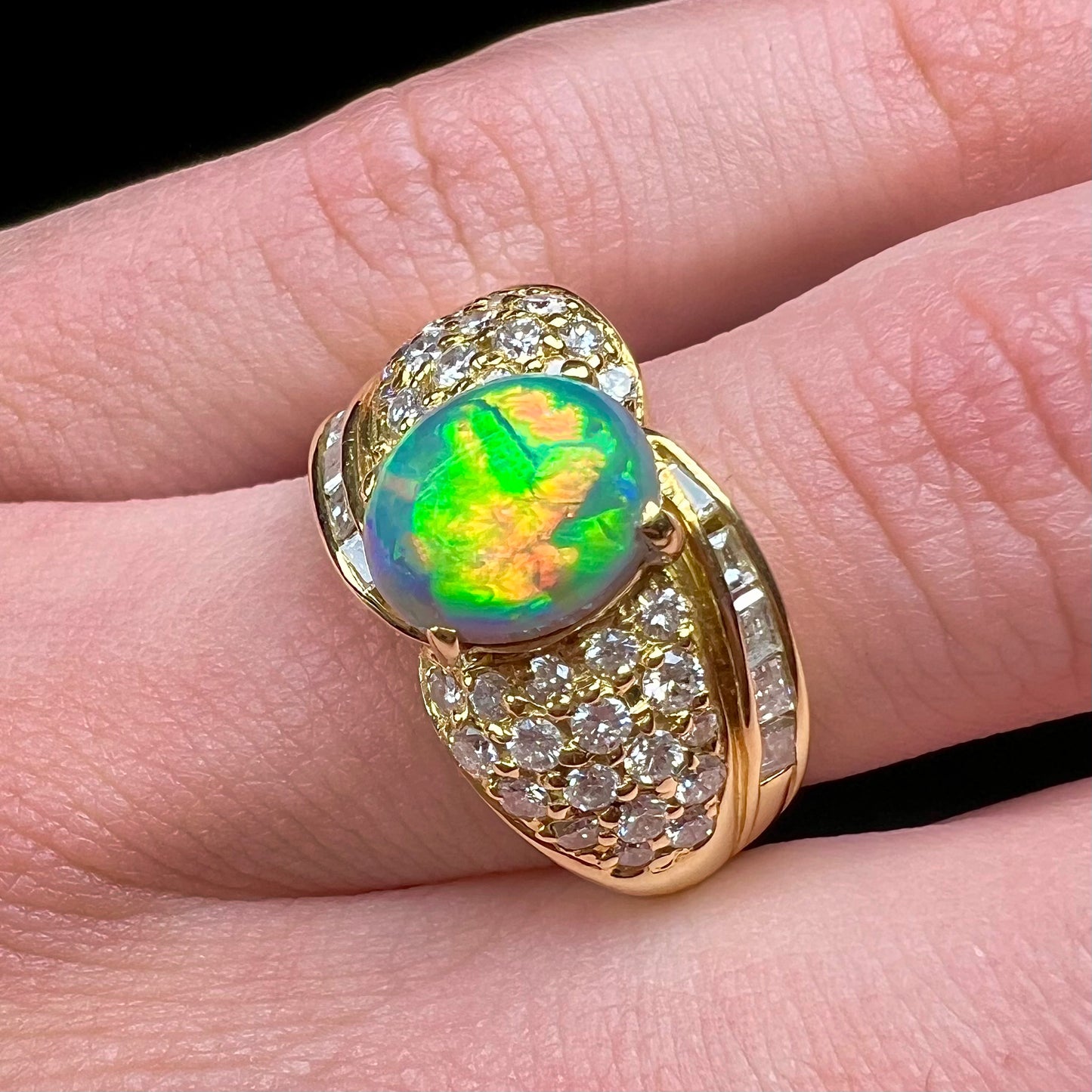 A natural, Australian black opal and diamond ring cast in 18 karat yellow gold..