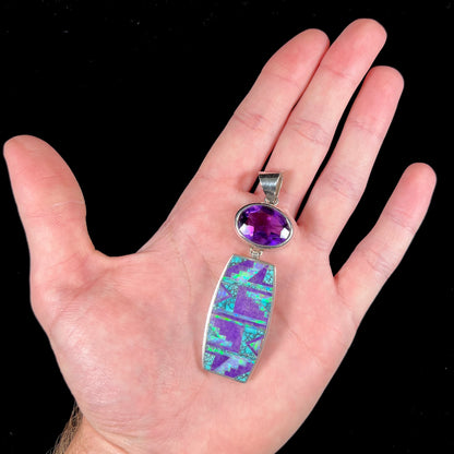 A sterling silver stone inlay necklace set with amethyst, sugilite, spiderweb turquoise, and lab created opal by Navajo artist, Peterson Chee.
