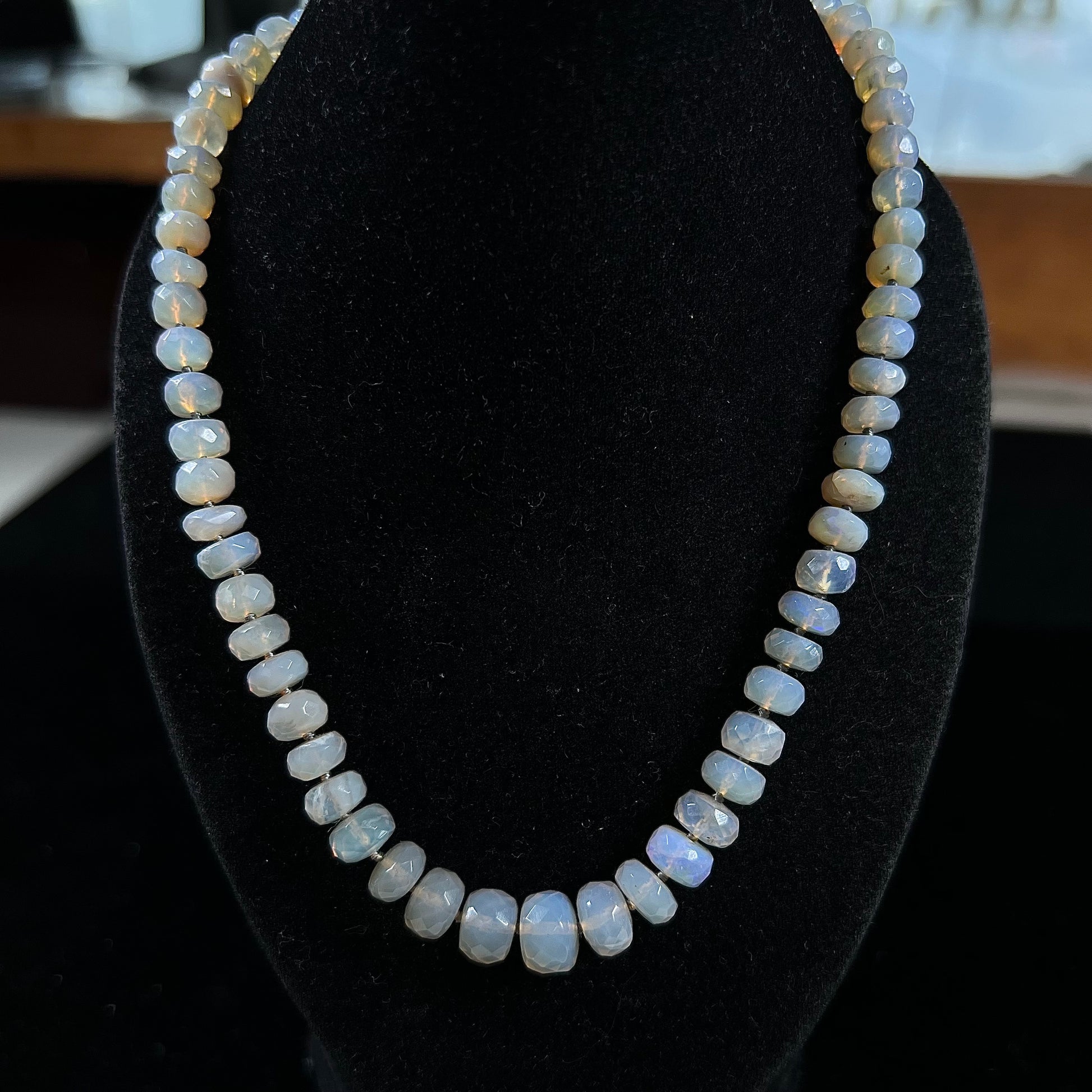 A necklace strand of faceted white crystal opal beads with a white gold clasp.