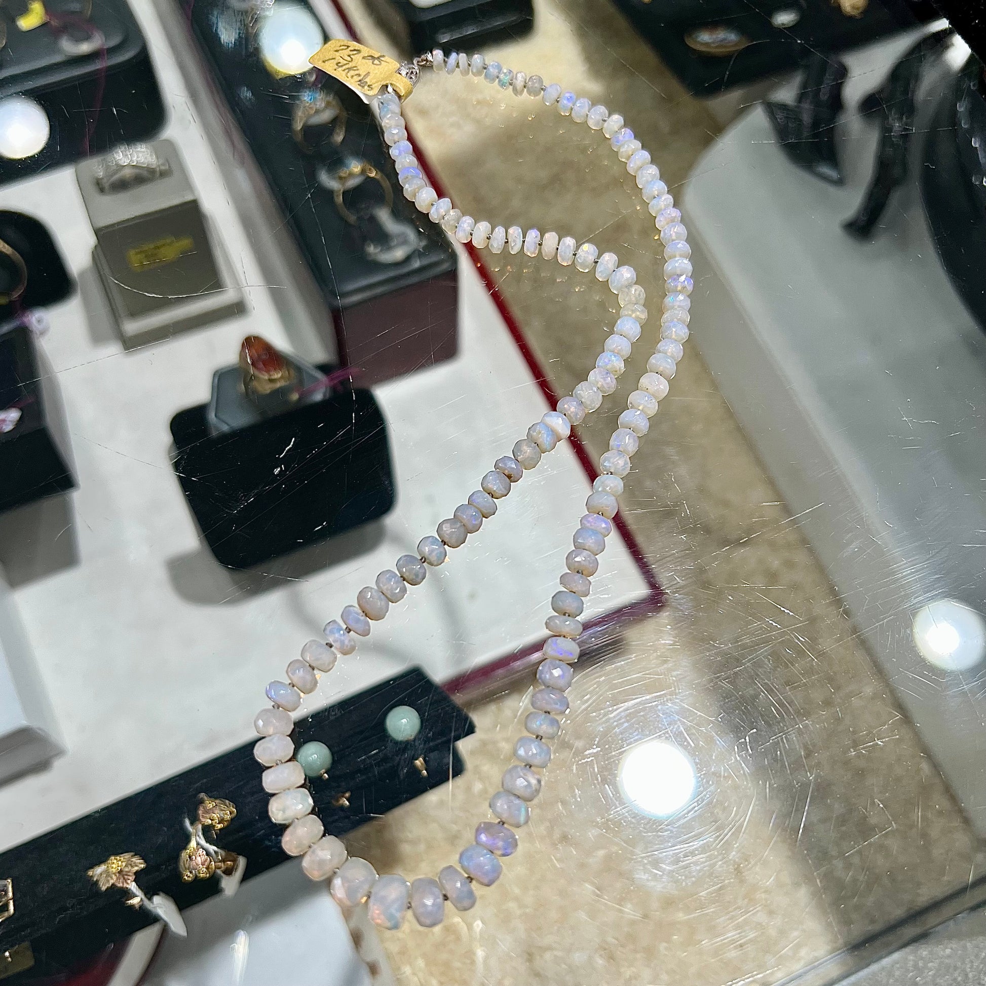 A necklace strand of faceted white crystal opal beads with a white gold clasp.