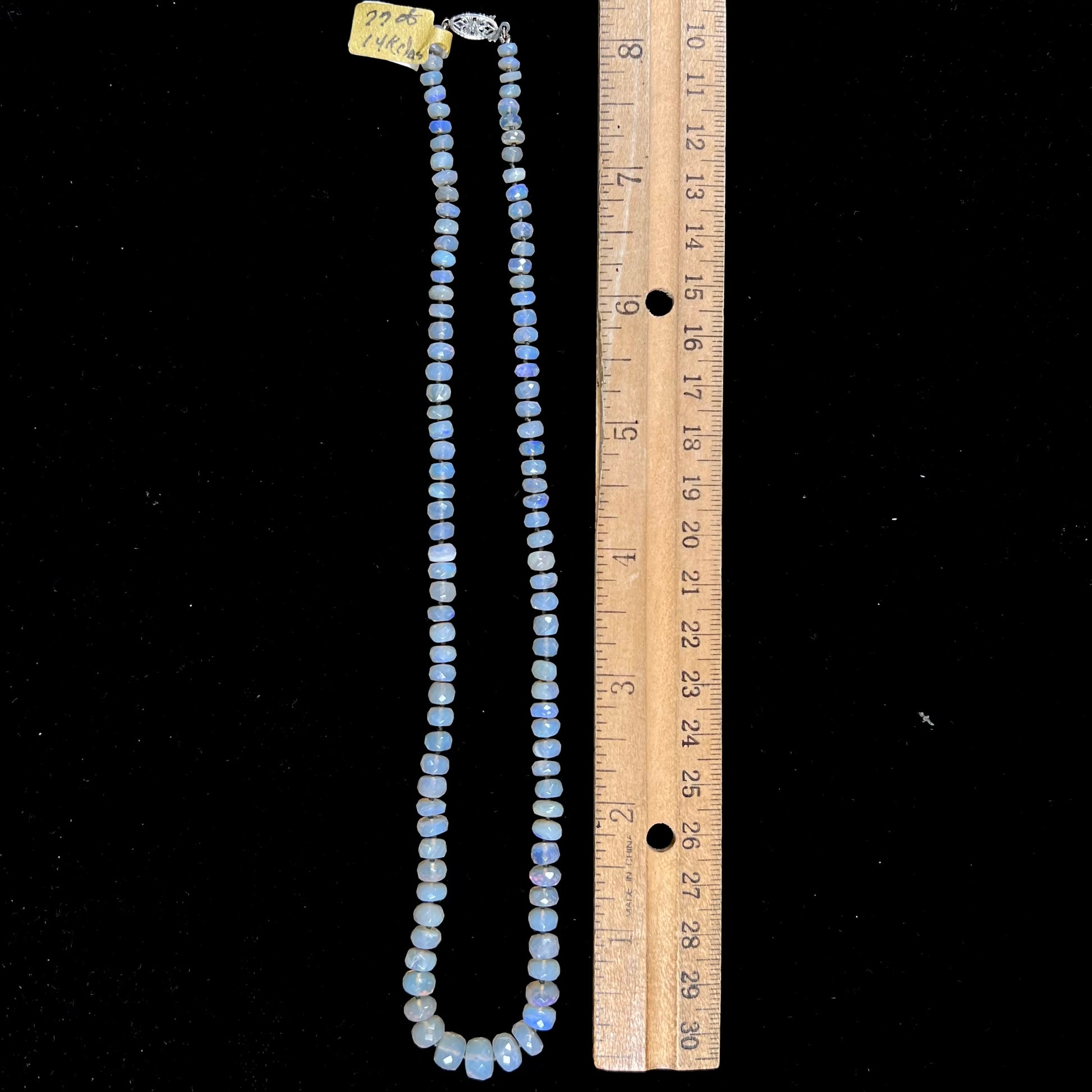 A necklace strand of faceted white crystal opal beads with a white gold clasp.
