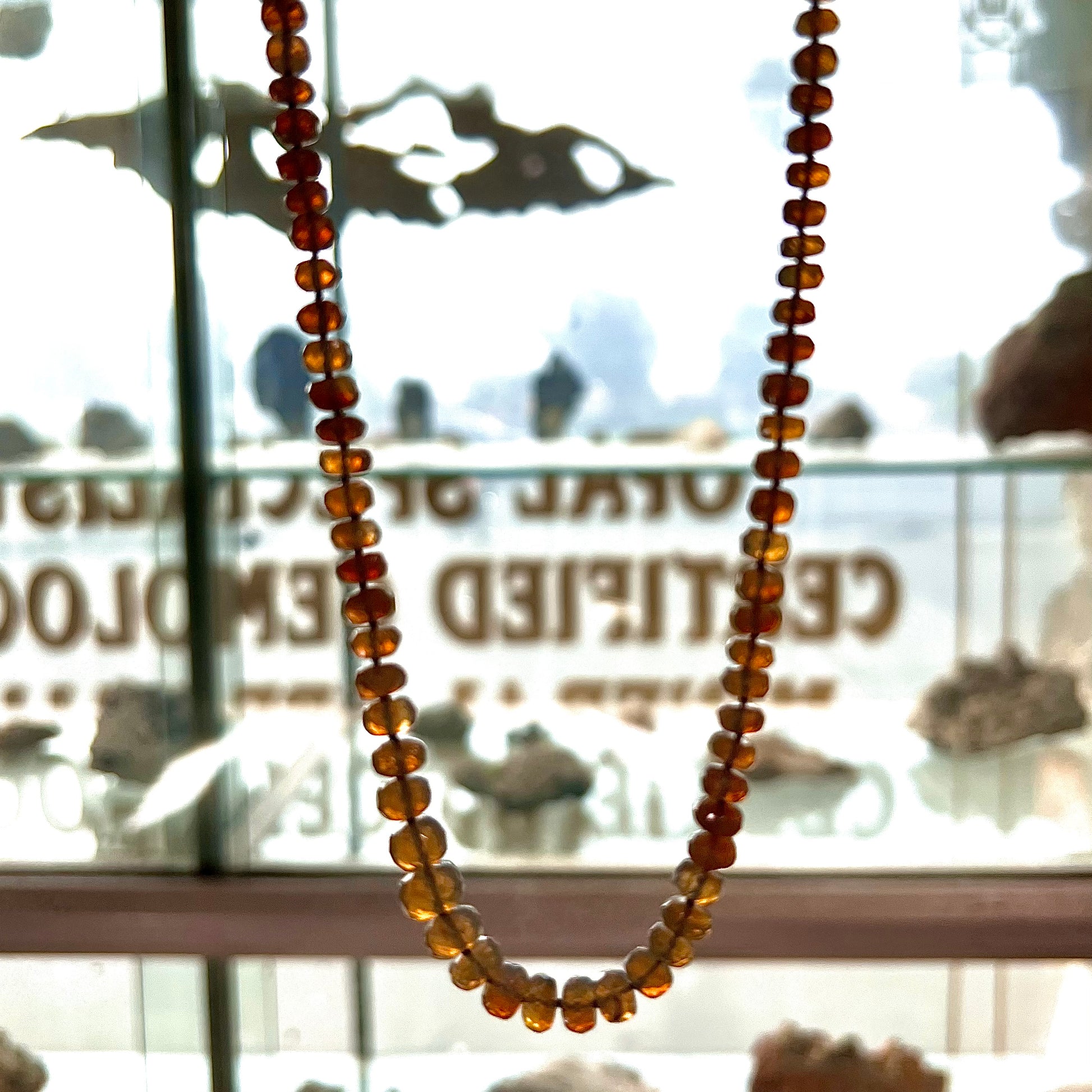 A necklace strand of faceted white crystal opal beads with a white gold clasp.