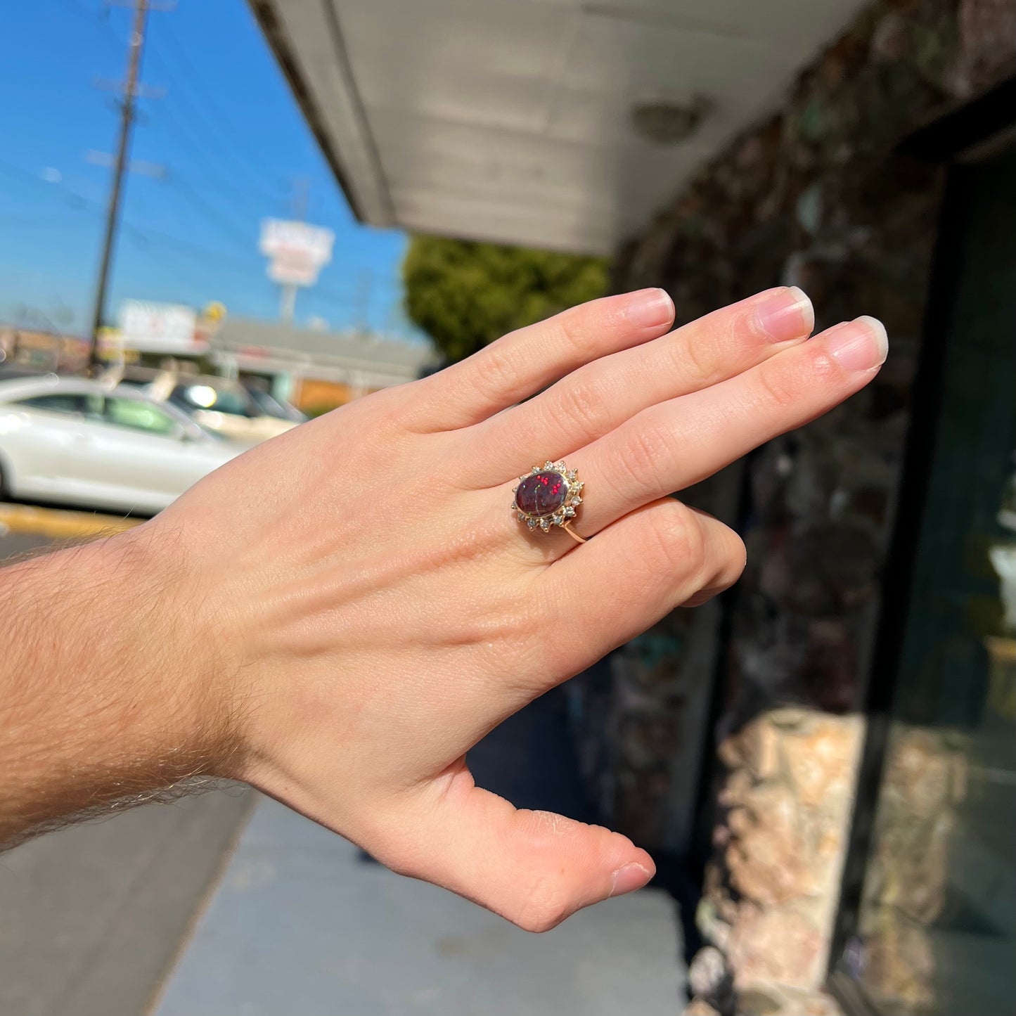 A ladies' diamond halo and Koroit boulder opal engagement ring.