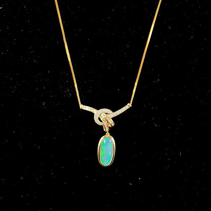 A gold black opal and diamond necklace.  There are round, princess cut, and baguette cut diamonds.