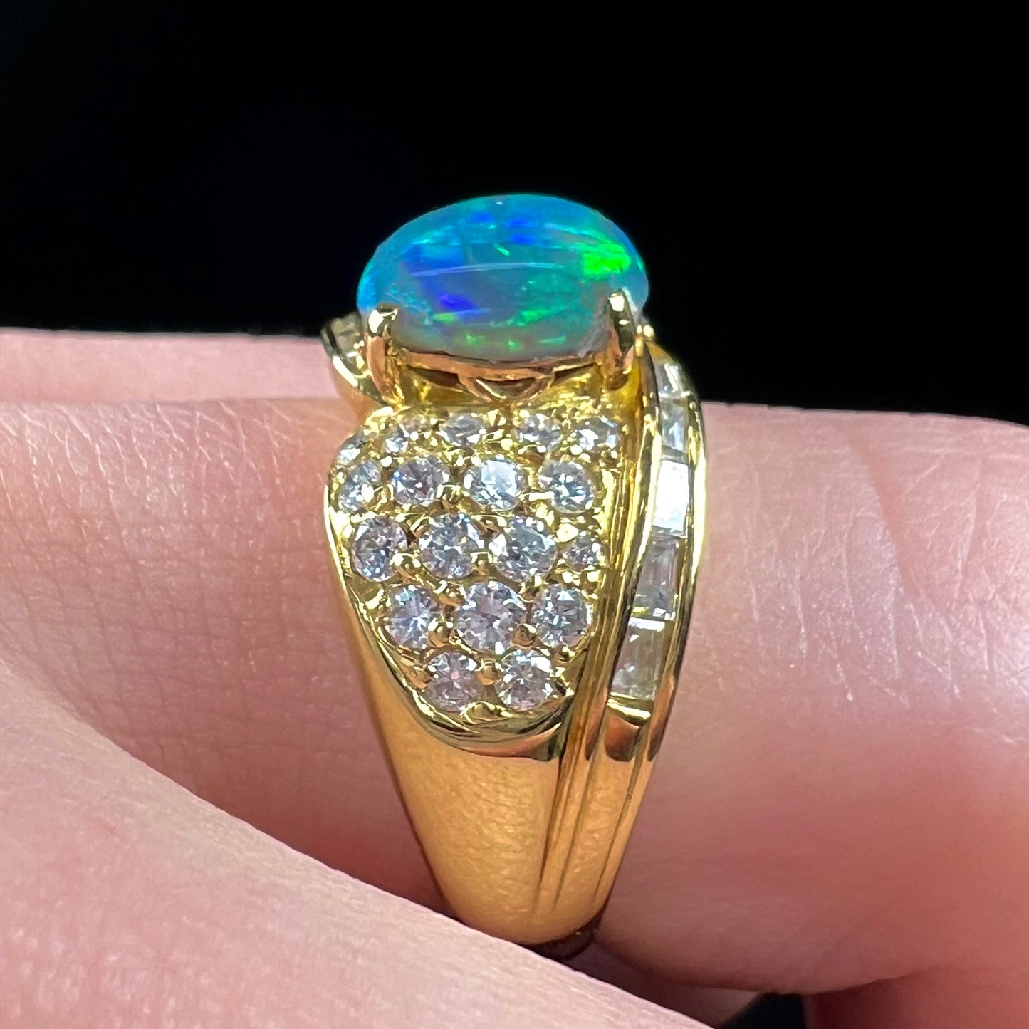 A natural, Australian black opal and diamond ring cast in 18 karat yellow gold..
